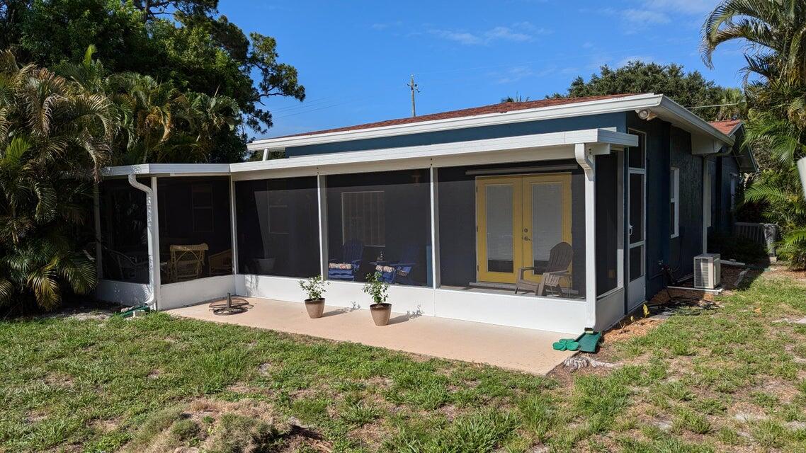 1202 East Madison Avenue Stuart, FL 34996 - Photo 19 of 23 a view of house with backyard and porch