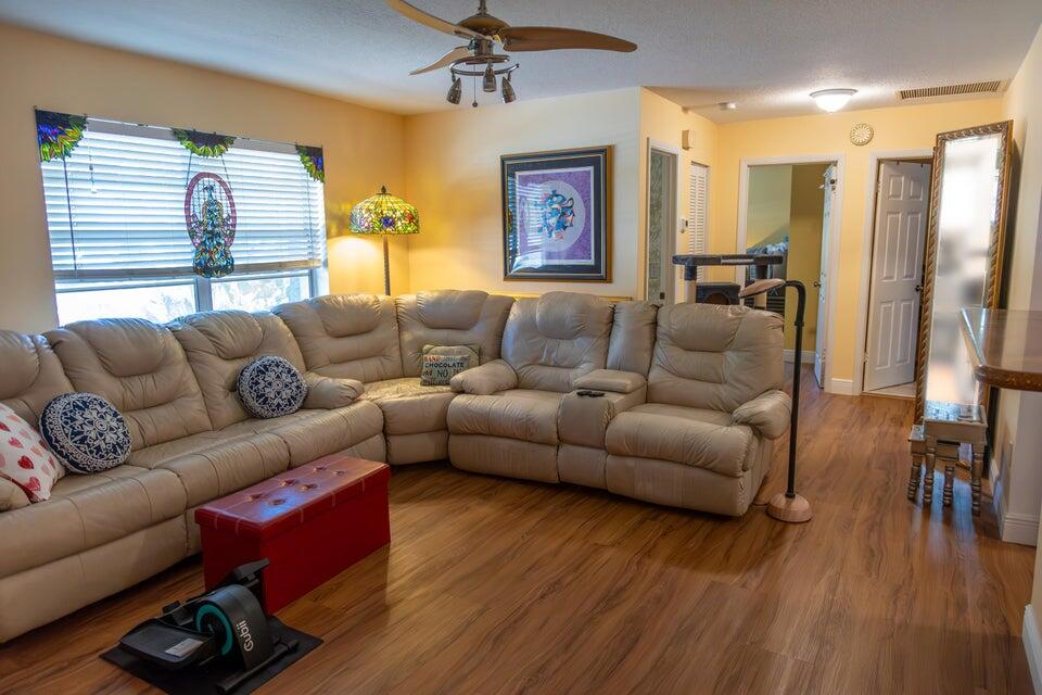 1202 East Madison Avenue Stuart, FL 34996 - Photo 2 of 23 a living room with furniture and a wooden floor
