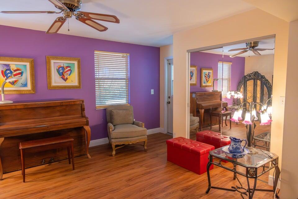 1202 East Madison Avenue Stuart, FL 34996 - Photo 3 of 23 a living room with furniture a ceiling fan and a window