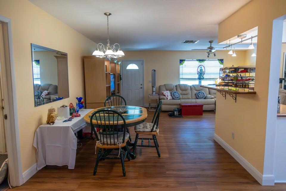 1202 East Madison Avenue Stuart, FL 34996 - Photo 7 of 23 a view of a dining room with furniture and wooden floor