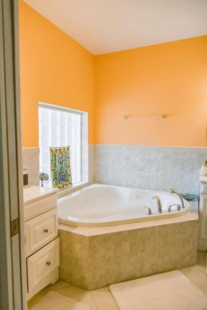 1202 East Madison Avenue Stuart, FL 34996 - Photo 10 of 23 a bath tub sitting in a bathroom next to a window