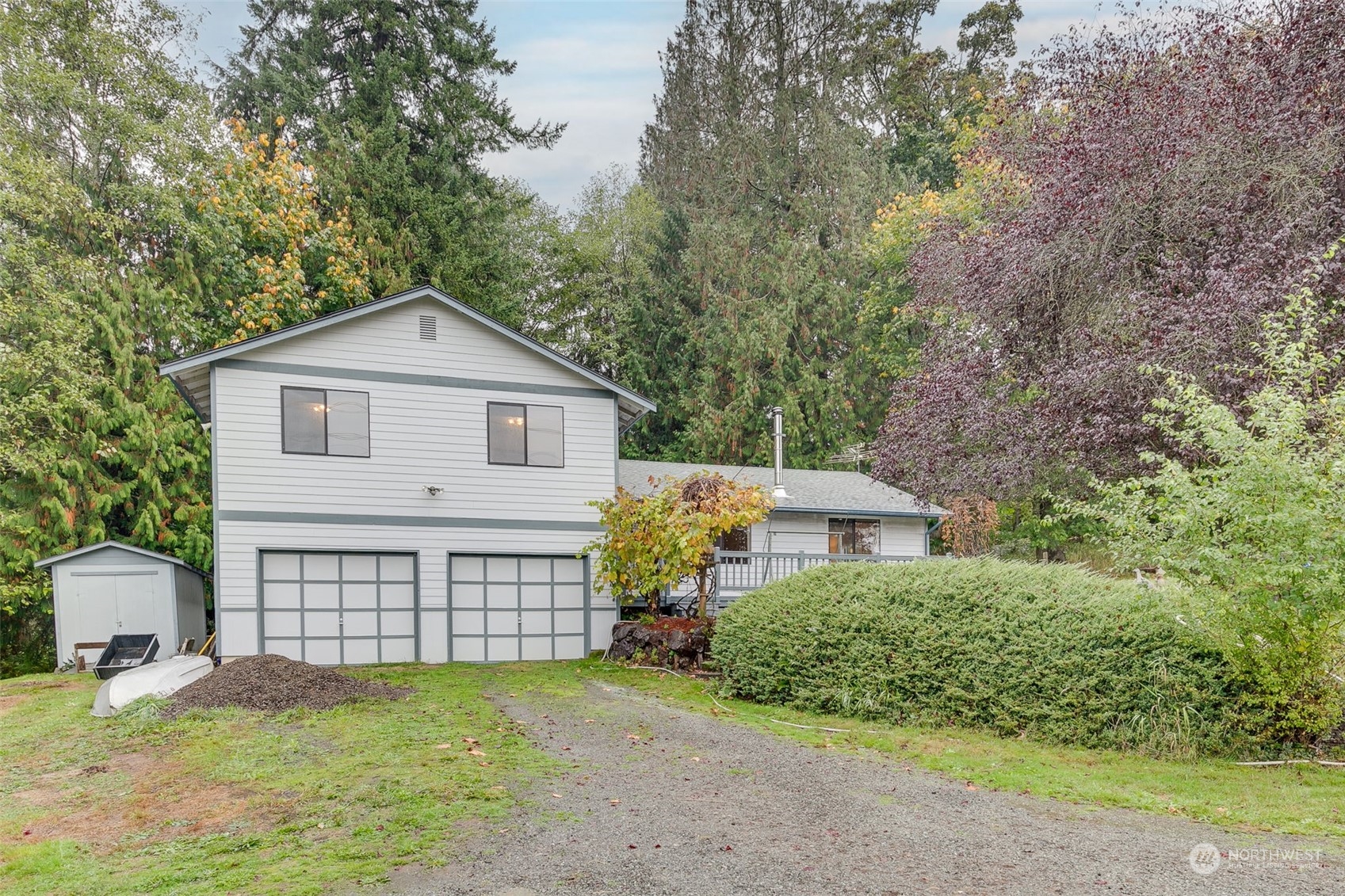 10021 Wagner Road Snohomish, WA 98290 - Photo 1 of 28 a front view of a house with a garden and yard