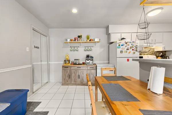 a kitchen with stainless steel appliances kitchen island granite countertop a refrigerator and a stove top oven