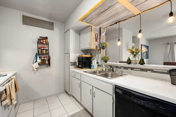 a kitchen with stainless steel appliances granite countertop white cabinets and white stove top oven