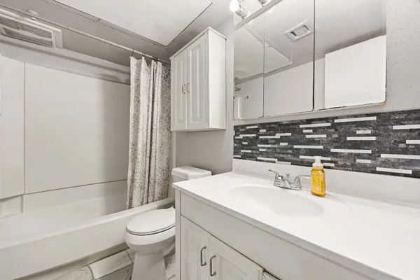 a bedroom with furniture and a flat screen tv