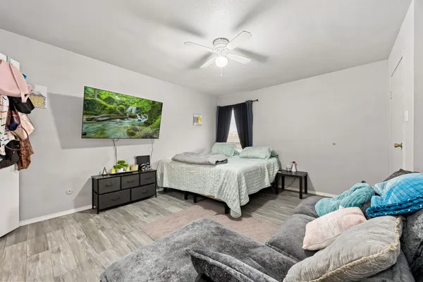 a bedroom with a bed couch and window