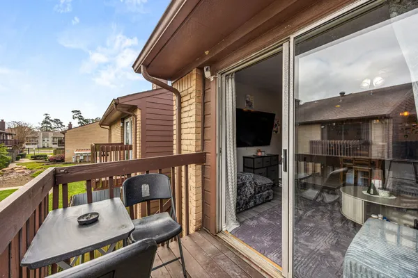 a front view of a house with a garden and plants