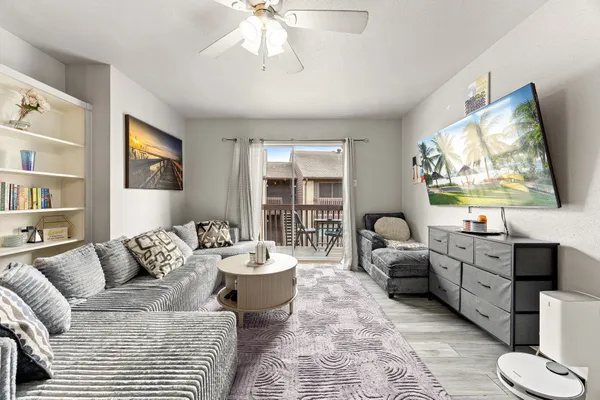 a living room with furniture and a wooden floor