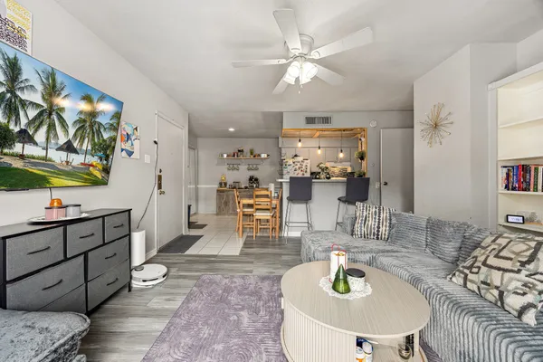 a kitchen with stainless steel appliances kitchen island granite countertop a table and chairs in it