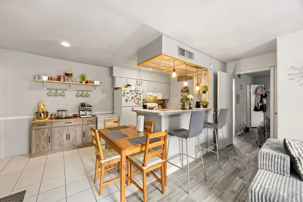 a kitchen with stainless steel appliances granite countertop a sink and a refrigerator