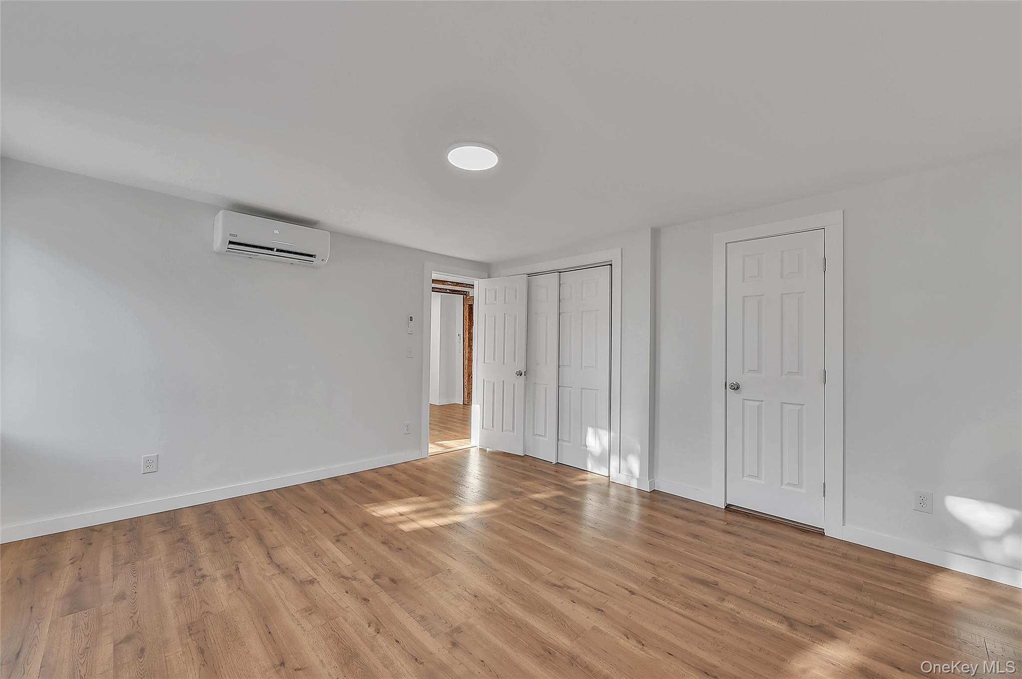 67 Jacobs Road Westtown, NY 10998 - Photo 30 of 36 Unfurnished bedroom with wood finished floors and a wall mounted AC