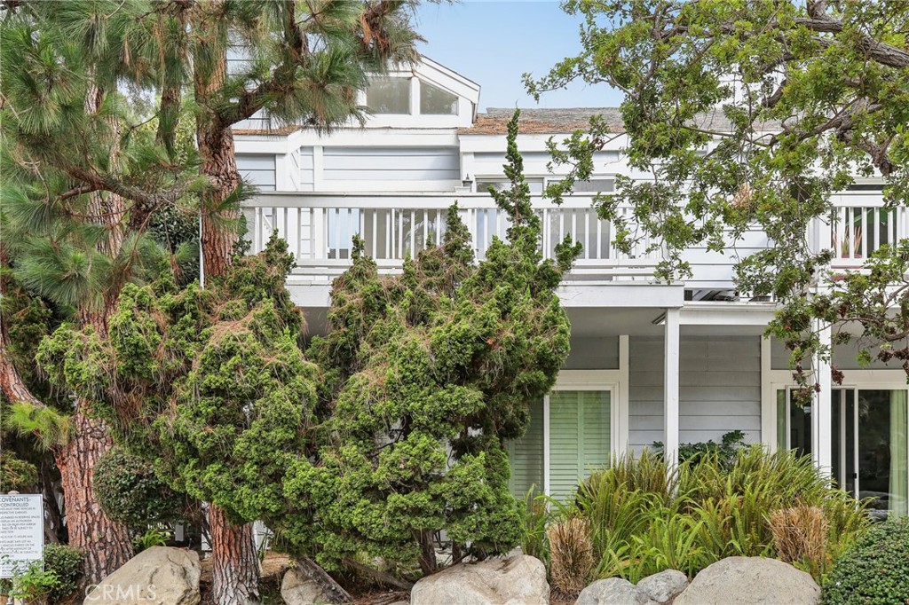 735 Wingate Bay, Unit 50 Costa Mesa, CA 92626 - Photo 2 of 32 a view of a building with a tree
