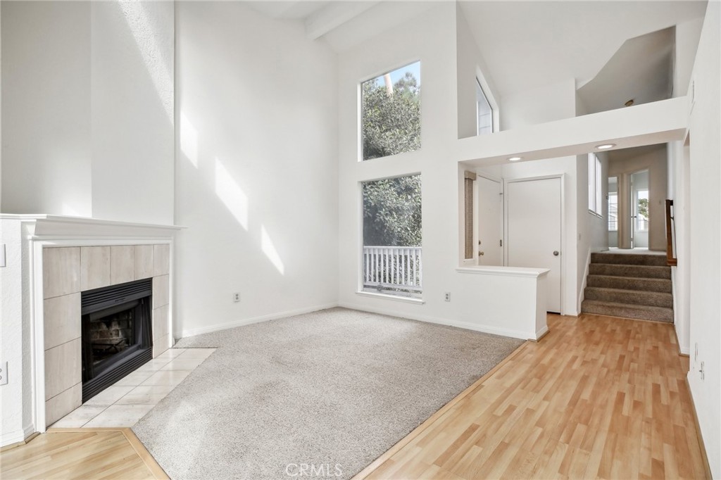 735 Wingate Bay, Unit 50 Costa Mesa, CA 92626 - Photo 4 of 32 a view of a livingroom with wooden floor and a fireplace