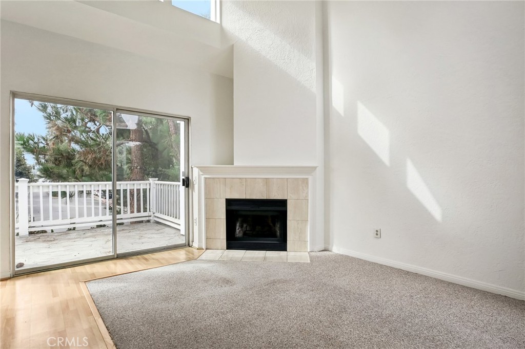 735 Wingate Bay, Unit 50 Costa Mesa, CA 92626 - Photo 5 of 32 a view of a livingroom with a fireplace and large windows
