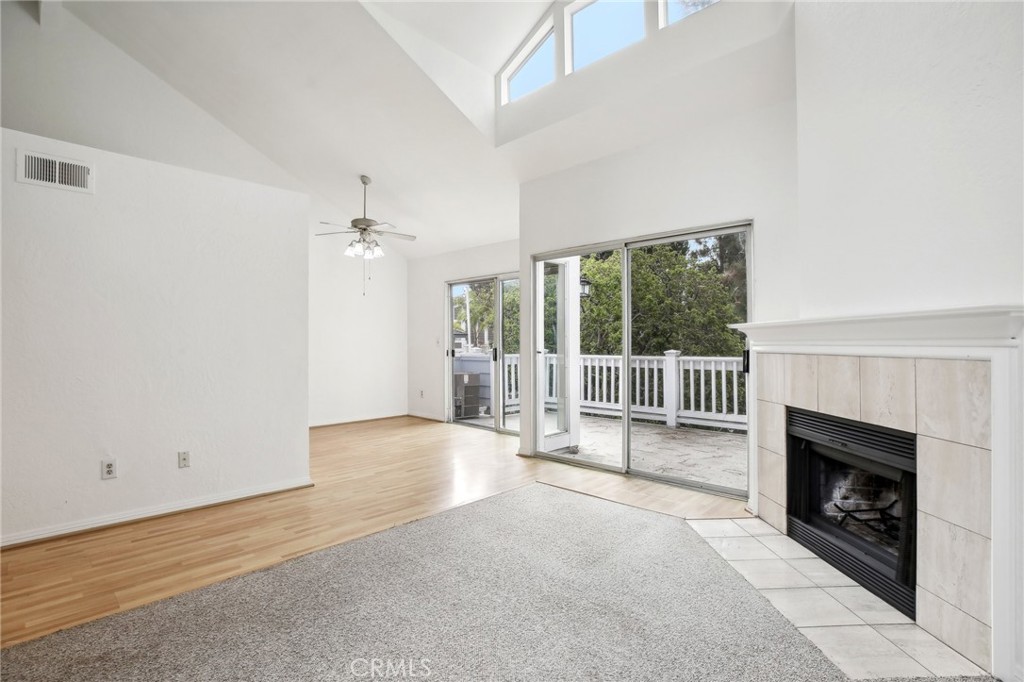 735 Wingate Bay, Unit 50 Costa Mesa, CA 92626 - Photo 6 of 32 an empty room with floor to ceiling window and an outdoor view