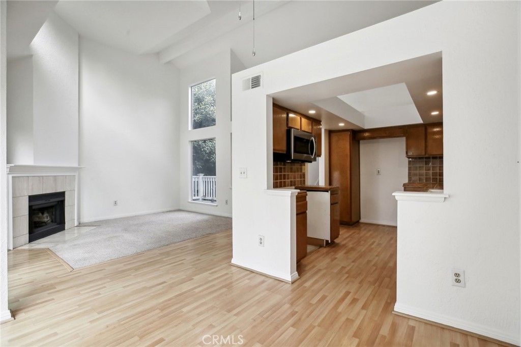 735 Wingate Bay, Unit 50 Costa Mesa, CA 92626 - Photo 9 of 32 a view of a kitchen with wooden floor and a kitchen
