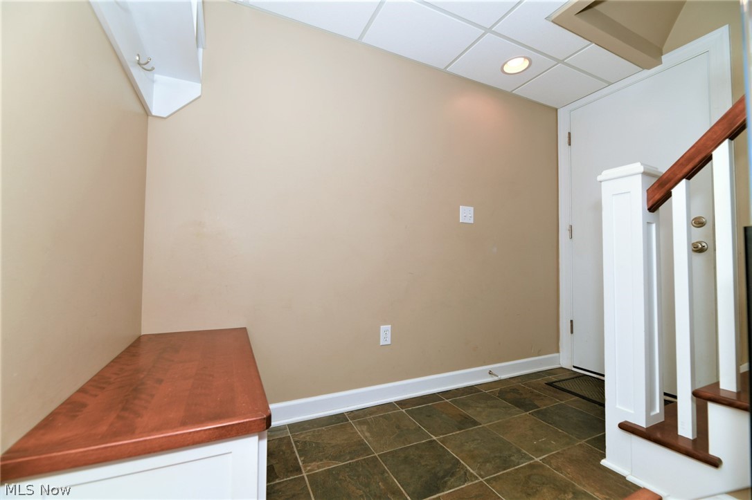 4425 Max Road North Canton, OH 44720 - Photo 20 of 30 *MAN DOOR FROM ATTACHED GARAGE LEADS TO TILED FLOORING, BUILT IN BENCH AND WALL COAT RACK (MUD ROOM AREA) W/NICE RAILING & STAIRWAY TO THE MAIN FLOOR ~