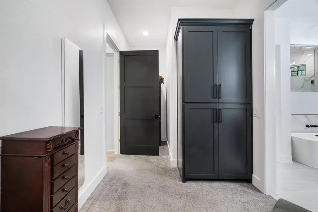 a view of hallway with cabinets