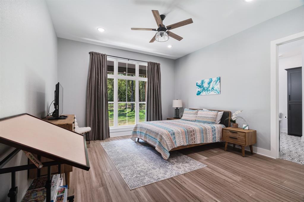 545 County Road Paris, TX 75462 - Photo 15 of 40 a bedroom with a bed a table and a potted plant