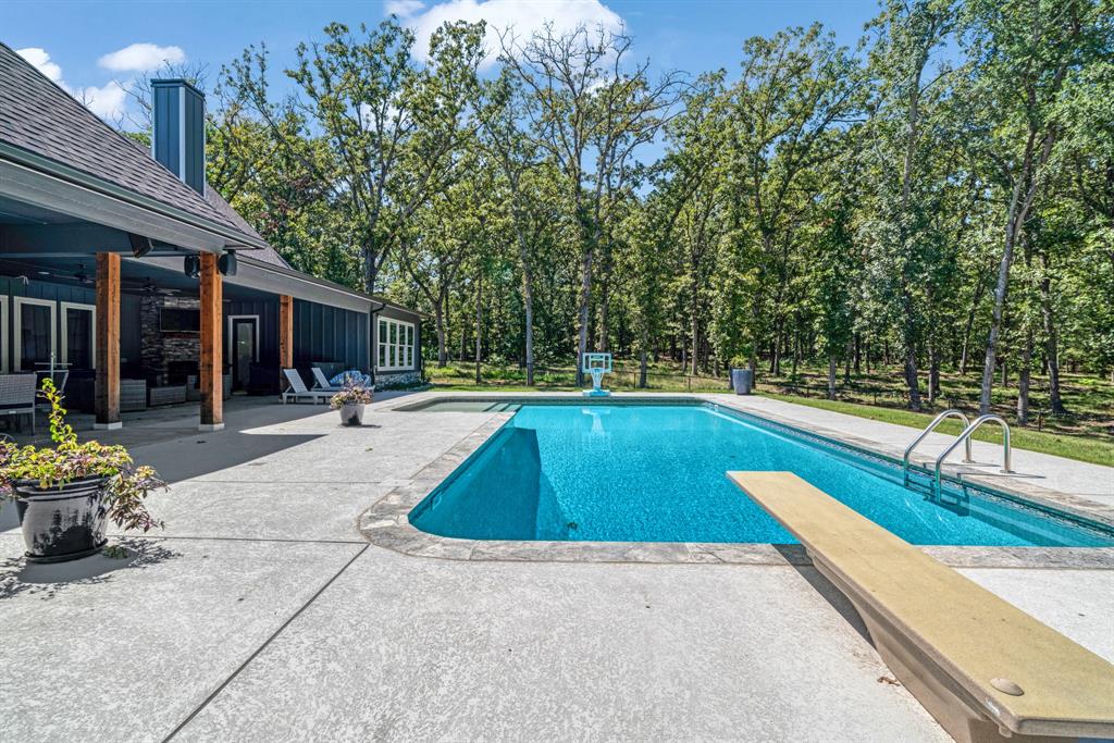 545 County Road Paris, TX 75462 - Photo 27 of 40 a view of a swimming pool with a lounge chair