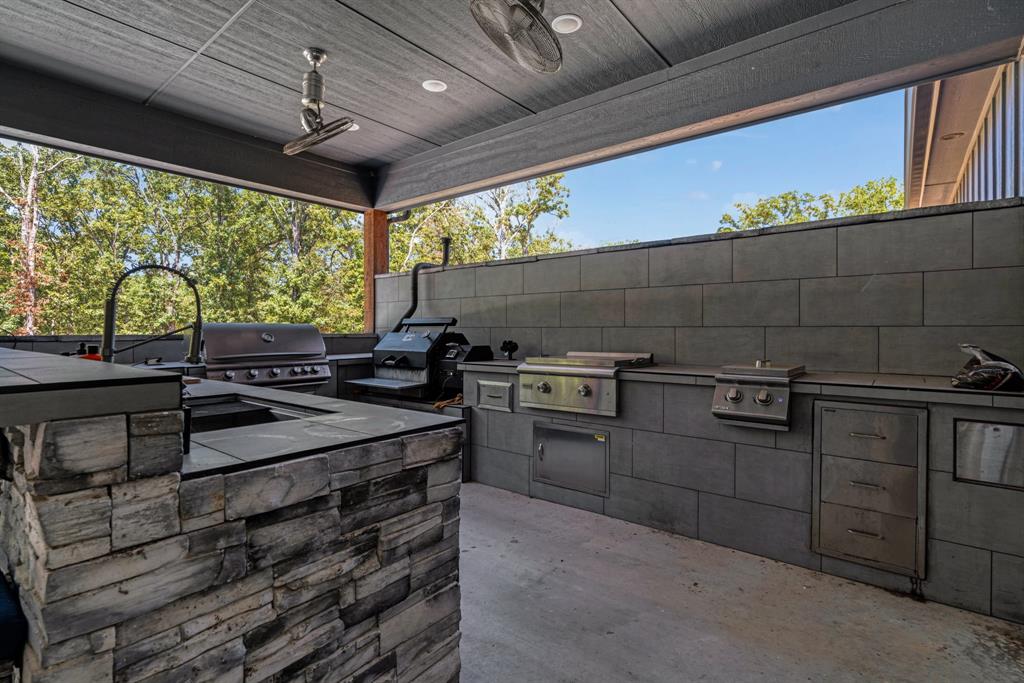 545 County Road Paris, TX 75462 - Photo 29 of 40 a kitchen with stainless steel appliances granite countertop a sink and a counter