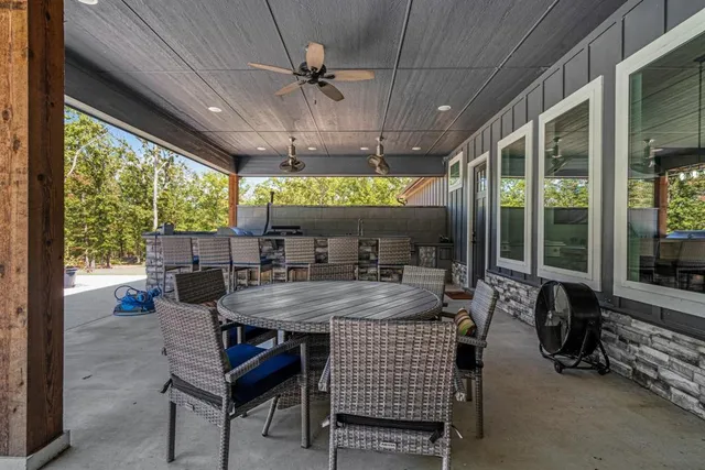 a view of a patio with a dining table and chairs