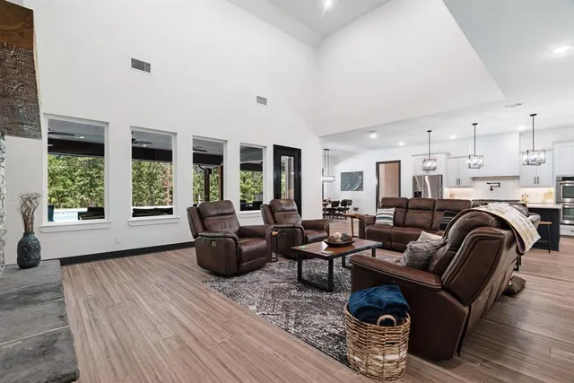 a living room with furniture and floor to ceiling windows