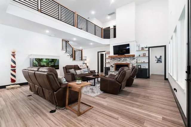 a living room with furniture a flat screen tv and a fireplace