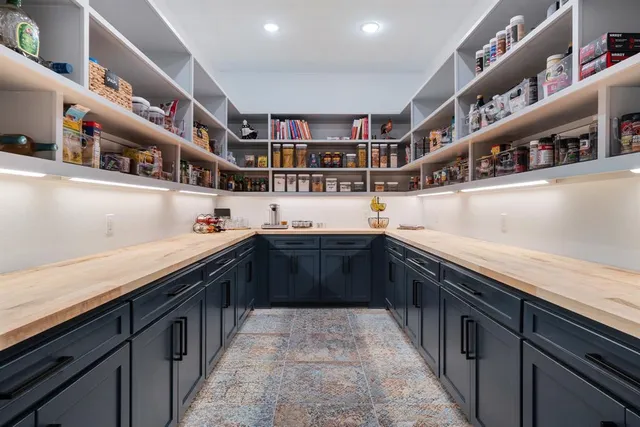 a kitchen with stainless steel appliances kitchen island granite countertop a sink and cabinets