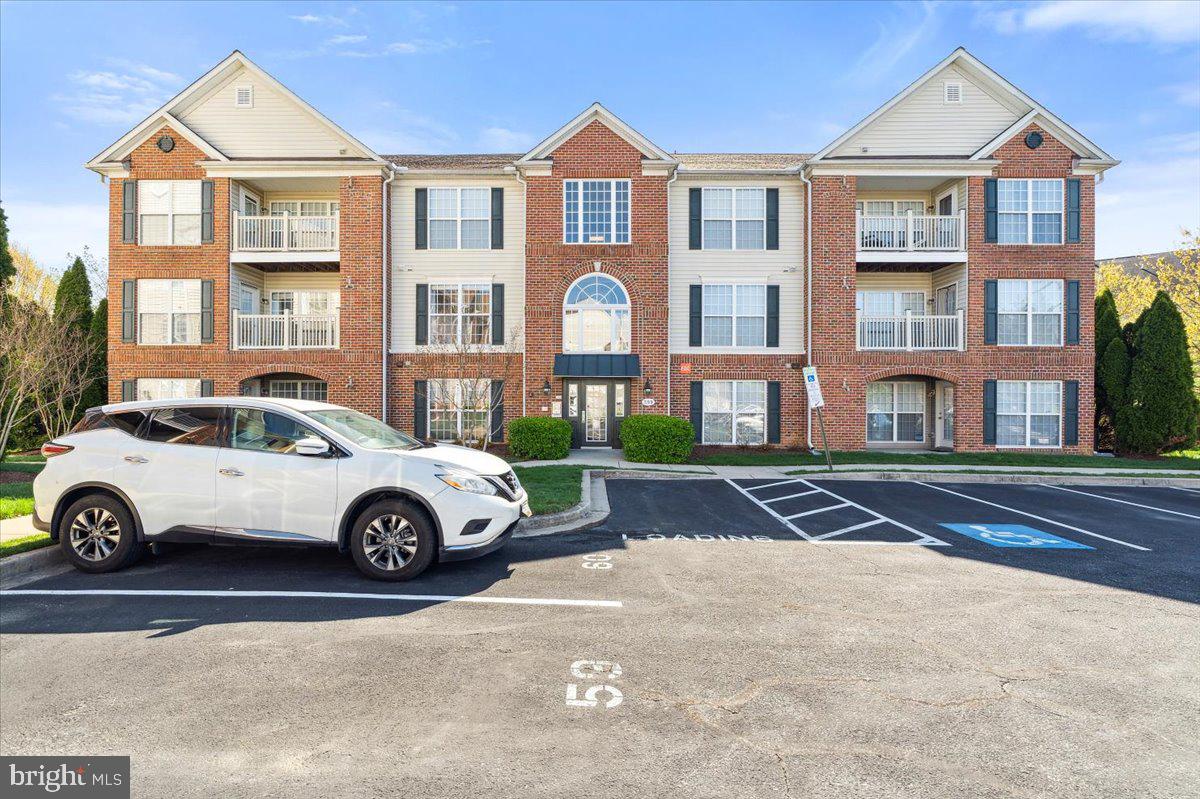 599 Cawley Drive, Unit 2A Frederick, MD 21703 - Photo 1 of 32 a front view of a residential apartment building with a yard