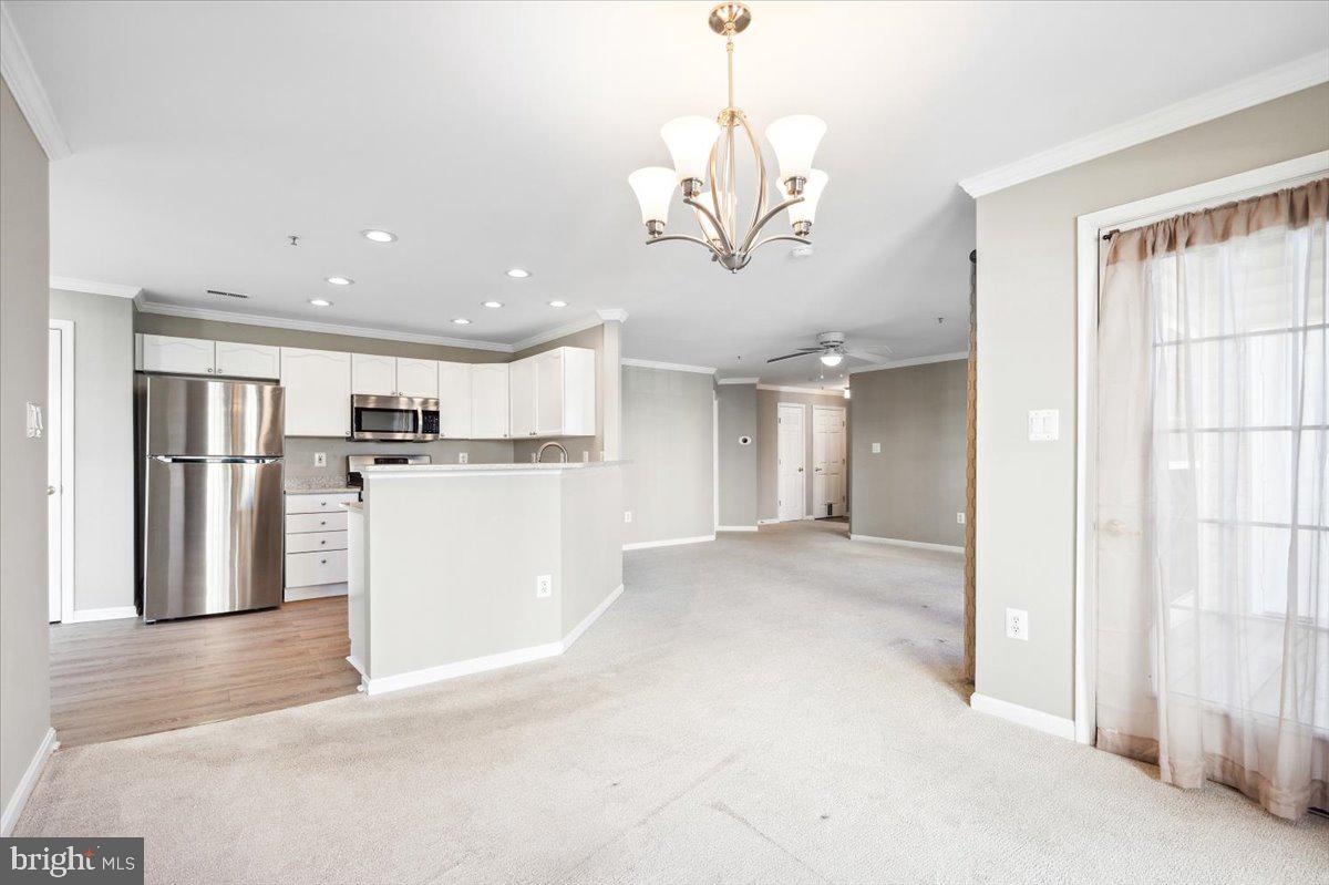599 Cawley Drive, Unit 2A Frederick, MD 21703 - Photo 14 of 32 a view of a room with stainless steel appliances kitchen island granite countertop a refrigerator a stove and a chandelier