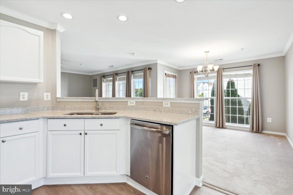 599 Cawley Drive, Unit 2A Frederick, MD 21703 - Photo 17 of 32 a kitchen with granite countertop a sink and a white cabinets
