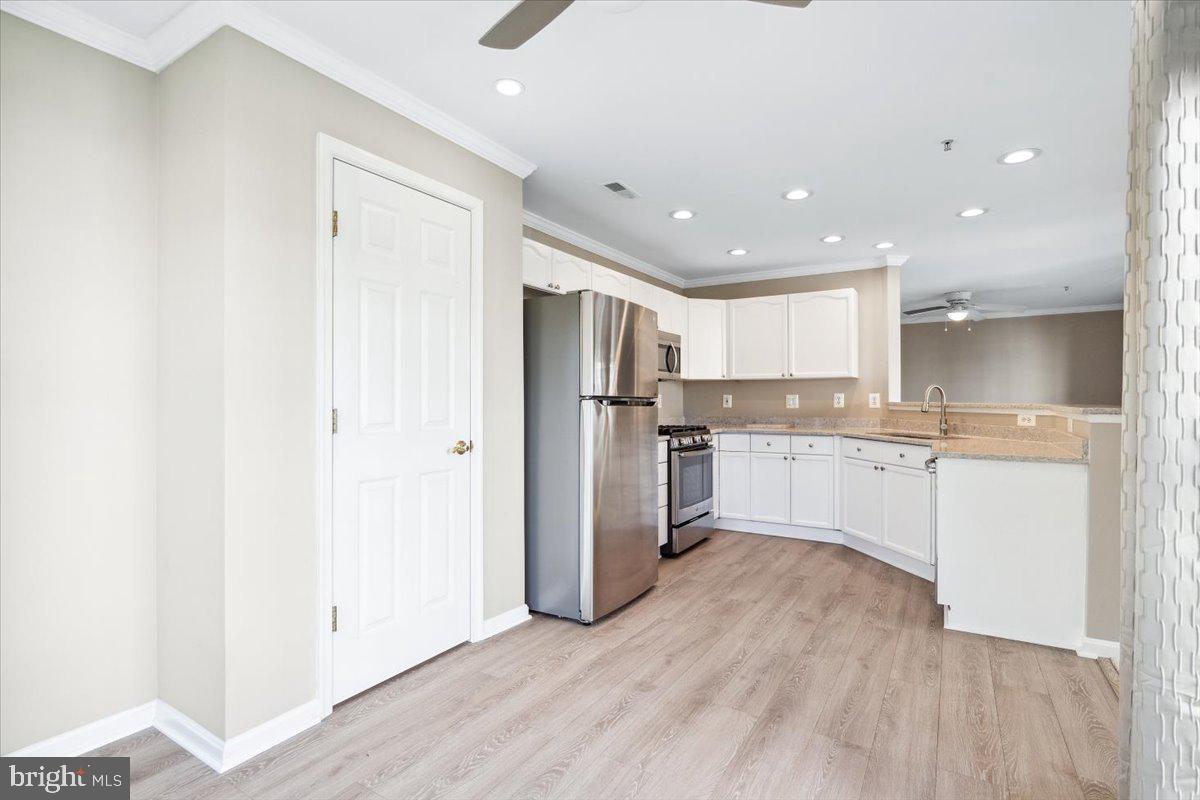 599 Cawley Drive, Unit 2A Frederick, MD 21703 - Photo 20 of 32 a kitchen with stainless steel appliances granite countertop a refrigerator sink and white cabinets