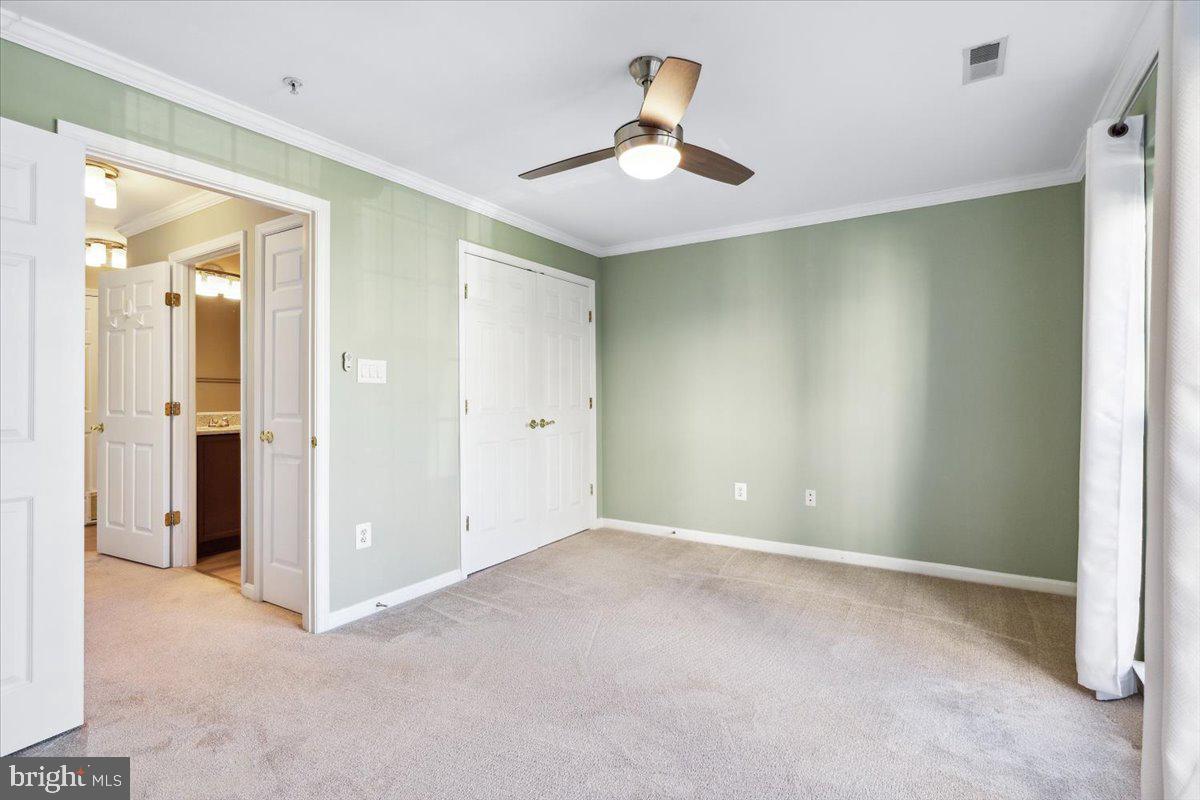 599 Cawley Drive, Unit 2A Frederick, MD 21703 - Photo 24 of 32 an empty room with closet and a chandelier fan