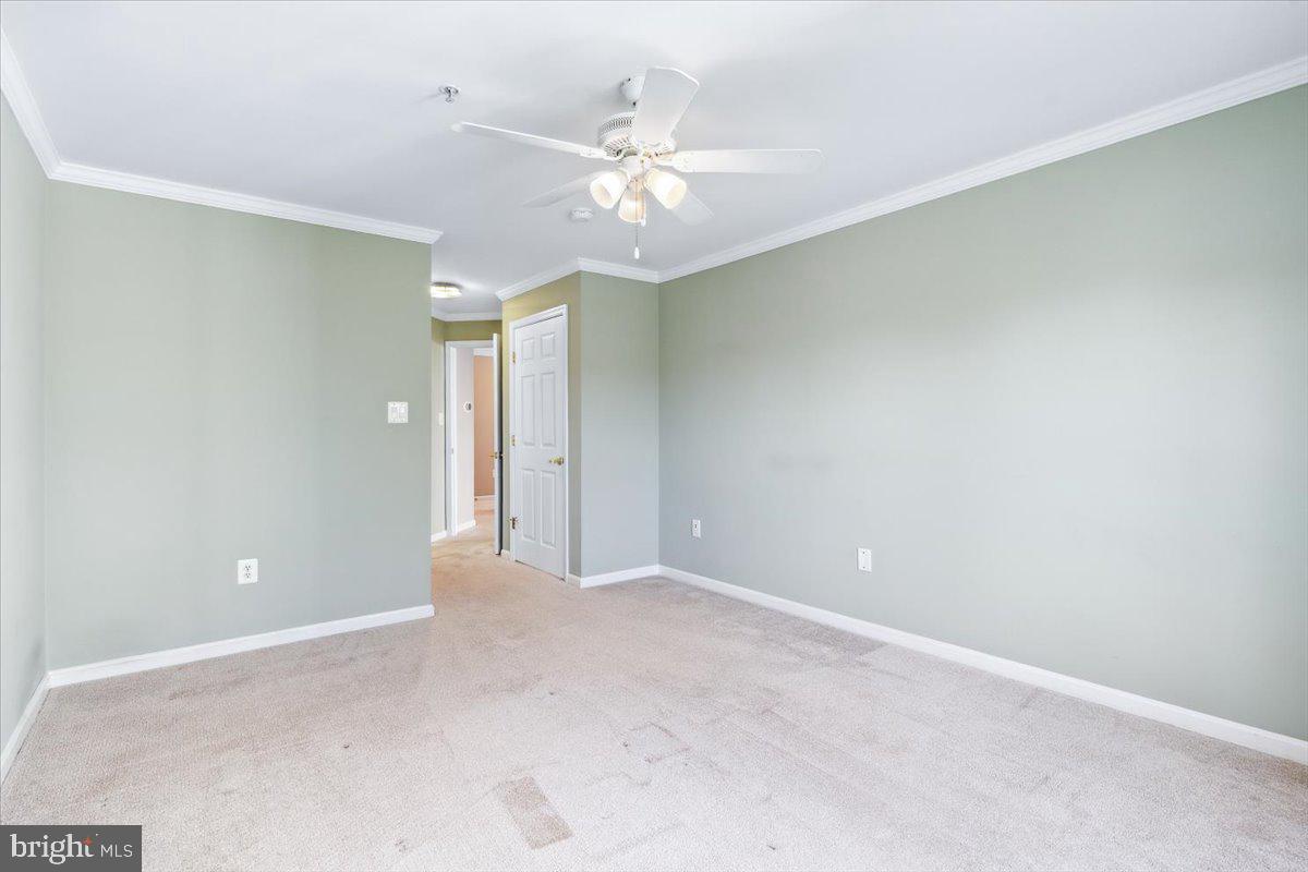 599 Cawley Drive, Unit 2A Frederick, MD 21703 - Photo 26 of 32 a view of an empty room with window and a ceiling fan
