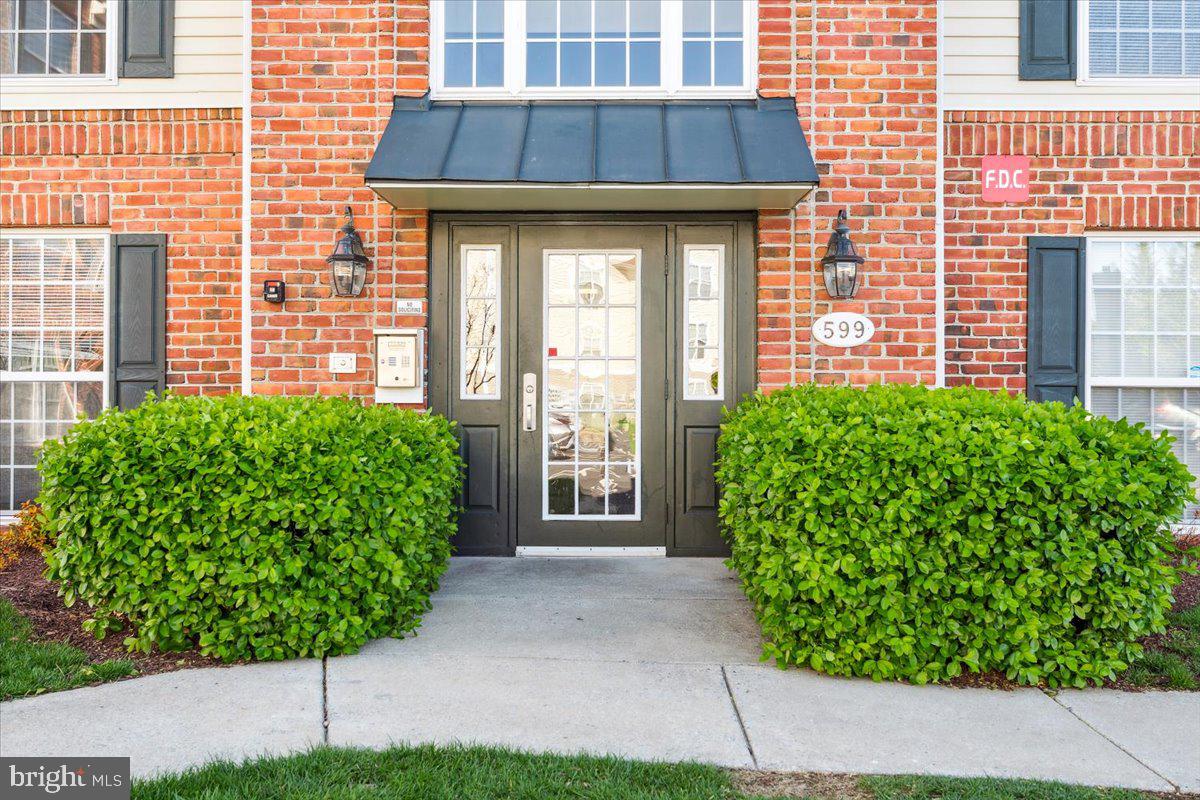 599 Cawley Drive, Unit 2A Frederick, MD 21703 - Photo 3 of 32 a front view of a house with garden