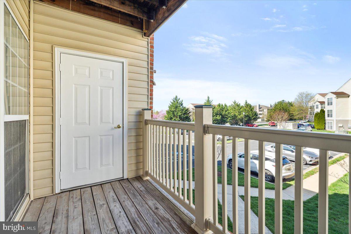 599 Cawley Drive, Unit 2A Frederick, MD 21703 - Photo 31 of 32 a view of a balcony with wooden floor and fence
