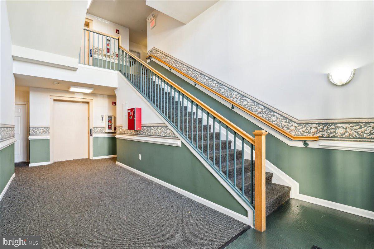 599 Cawley Drive, Unit 2A Frederick, MD 21703 - Photo 4 of 32 a view of a staircase and a living room