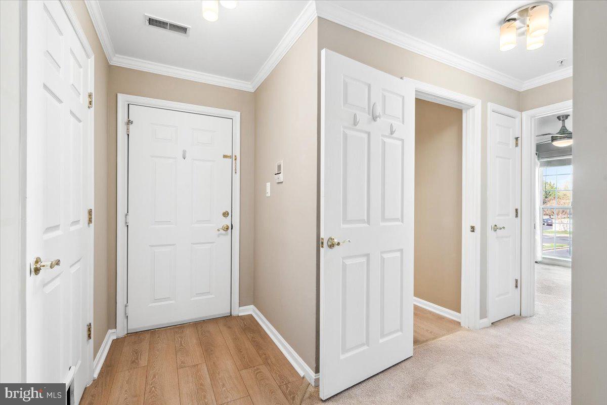 599 Cawley Drive, Unit 2A Frederick, MD 21703 - Photo 6 of 32 wooden floor with white walls