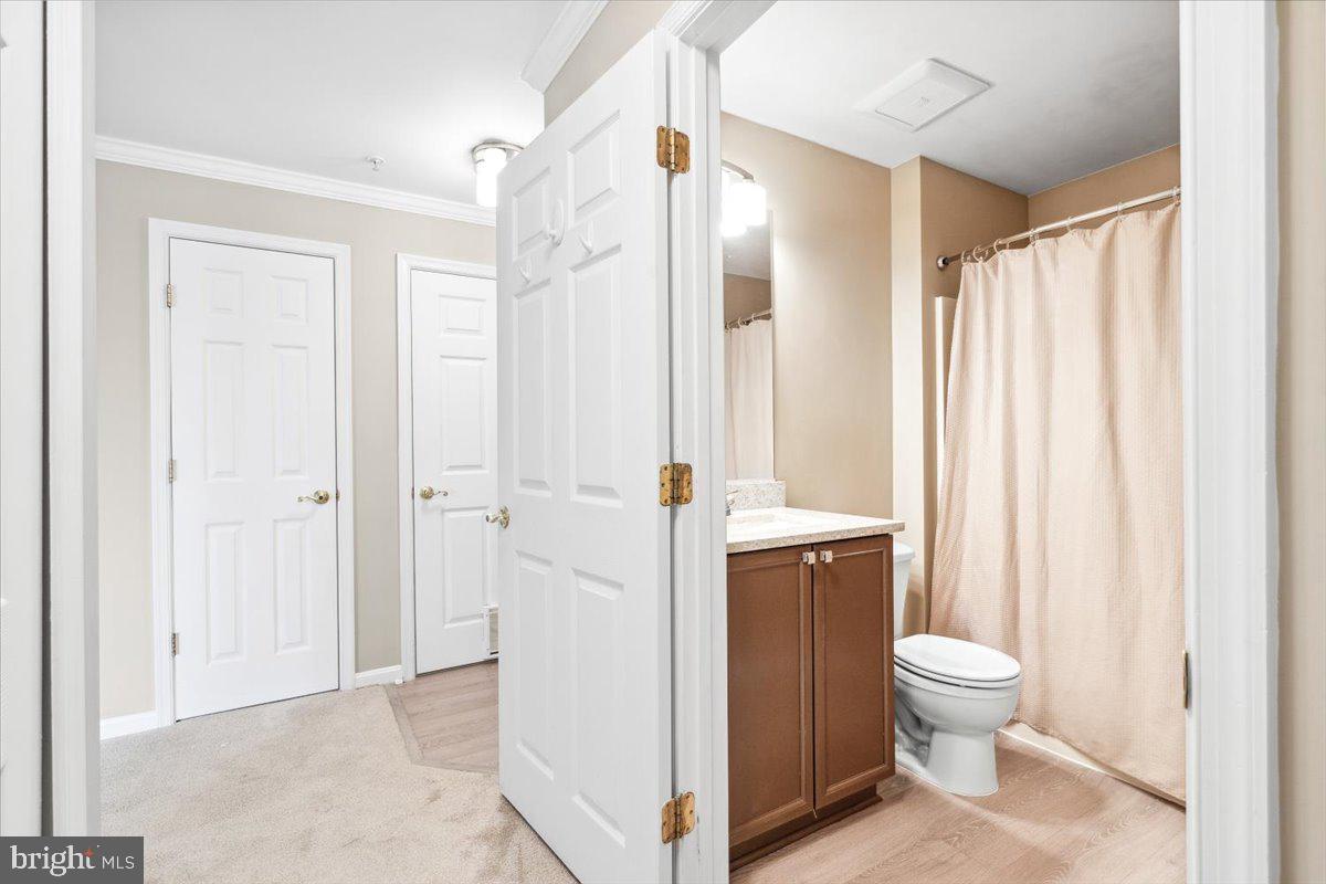 599 Cawley Drive, Unit 2A Frederick, MD 21703 - Photo 7 of 32 a bathroom with a toilet a sink and a shower