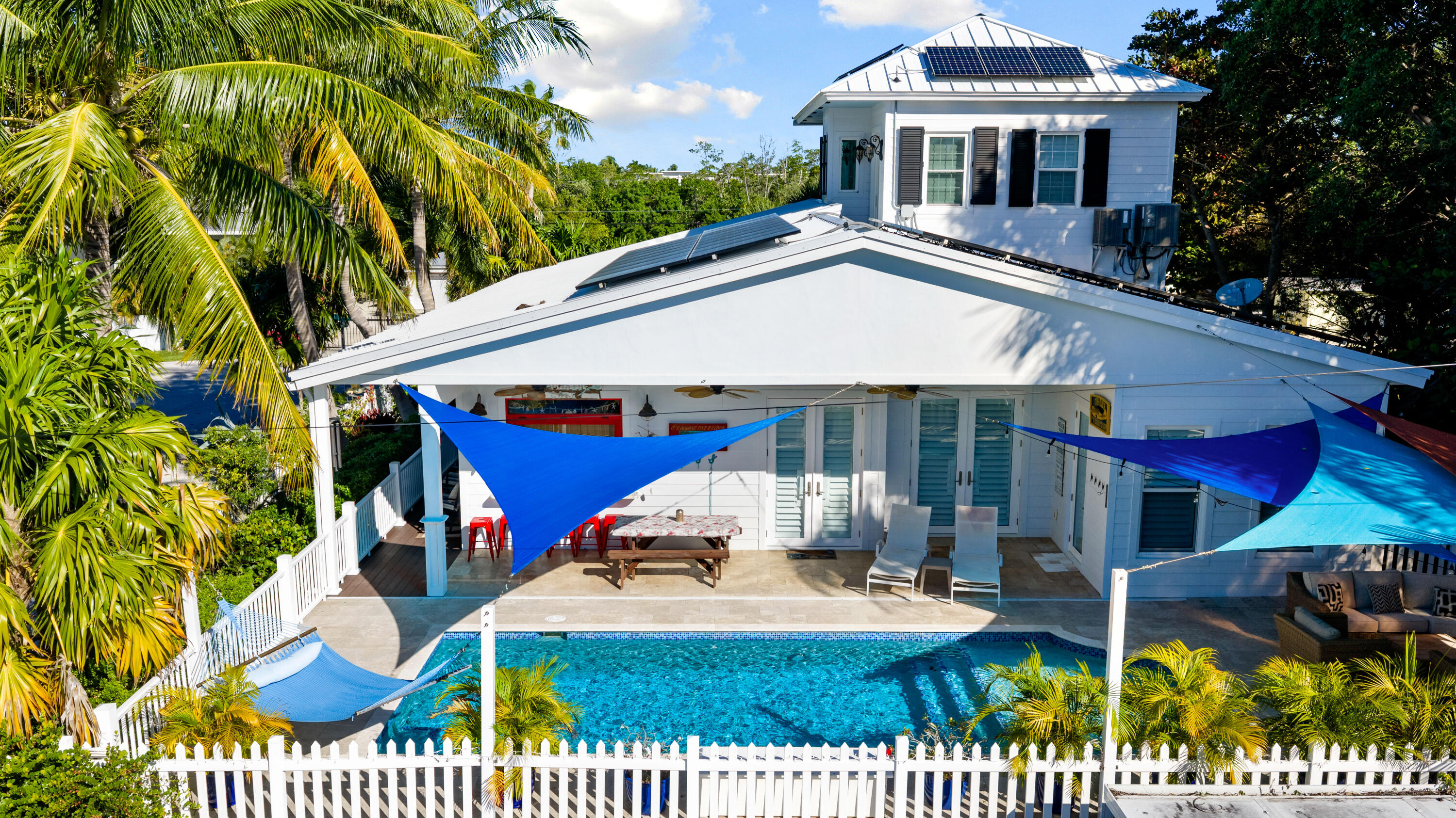 65 Tarpon Avenue Key Largo, FL 33037 - Photo 33 of 54 a view of a white house with a yard and furniture