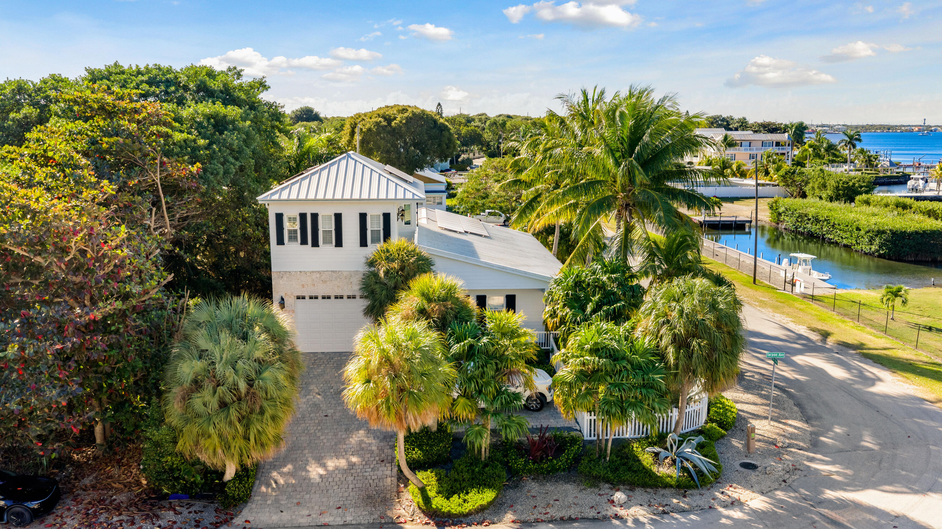65 Tarpon Avenue Key Largo, FL 33037 - Photo 36 of 54 a front view of a house with a yard and potted plants