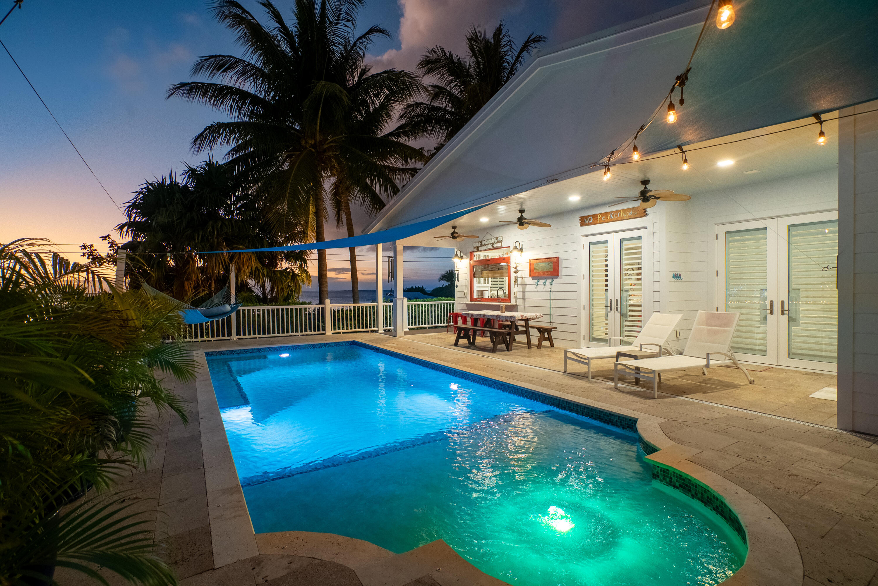 65 Tarpon Avenue Key Largo, FL 33037 - Photo 44 of 54 a view of a swimming pool with outdoor seating