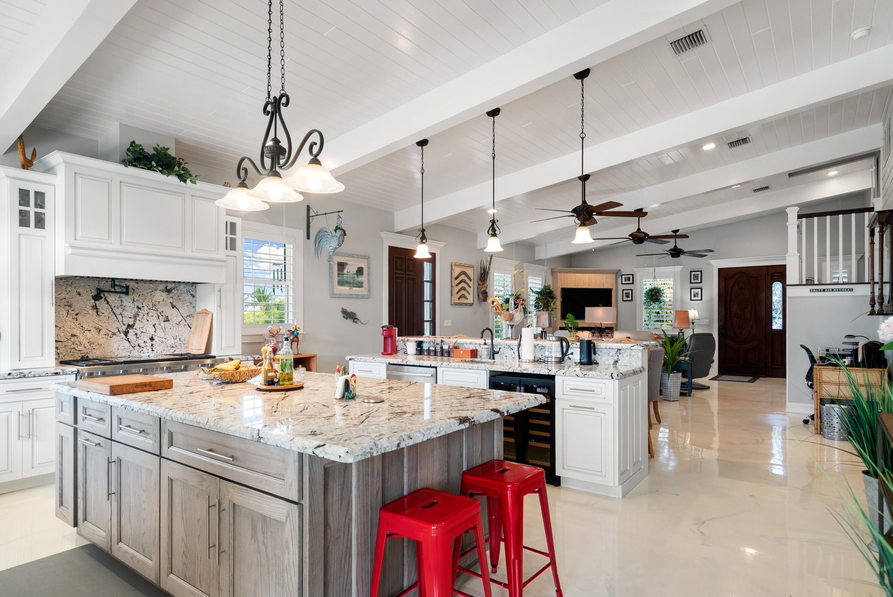 65 Tarpon Avenue Key Largo, FL 33037 - Photo 7 of 54 a open kitchen with stainless steel appliances granite countertop a sink stove and refrigerator with wooden floor
