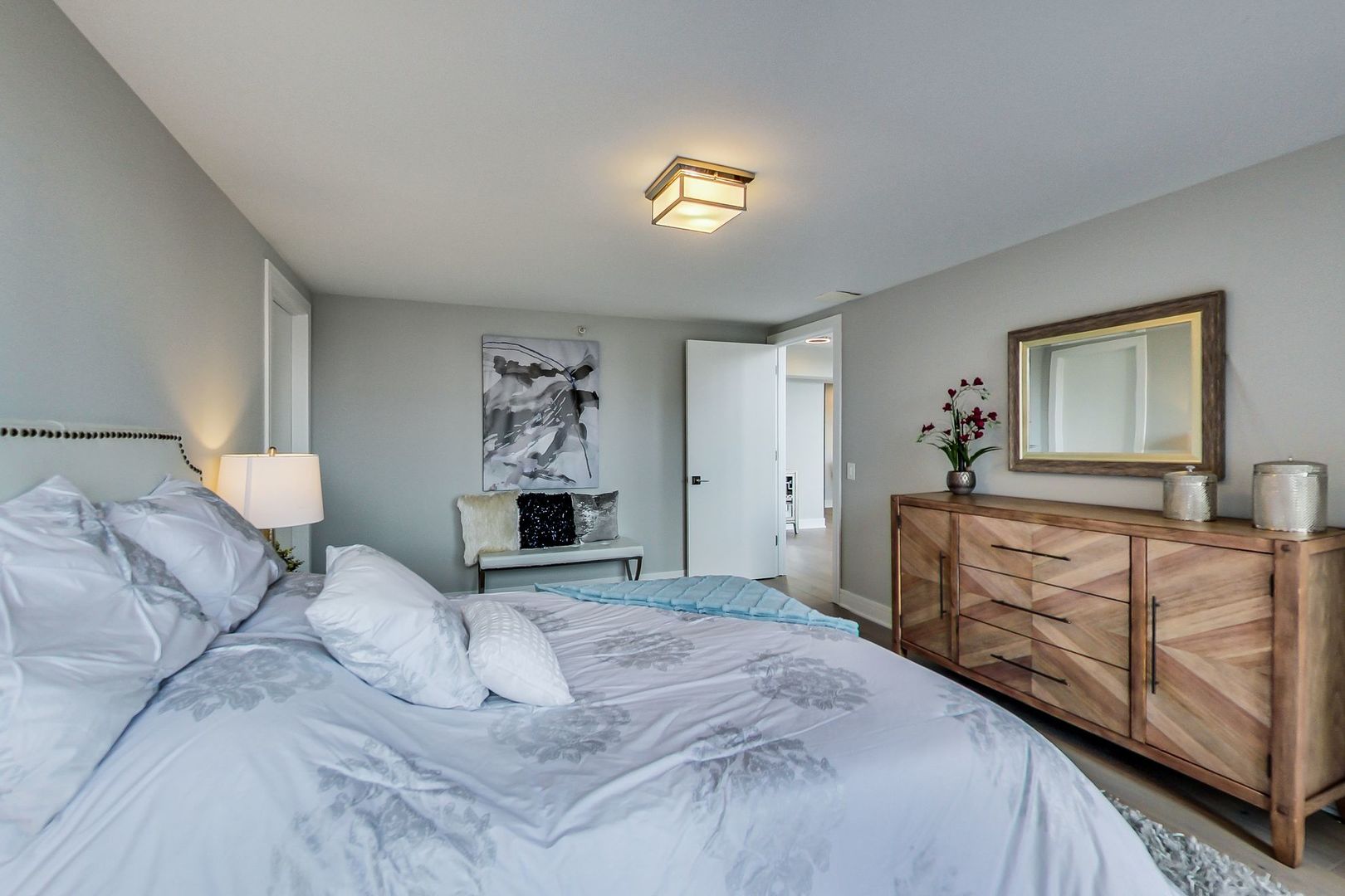 545 North Dearborn Street, Unit 3603 Chicago, IL 60654 - Photo 26 of 42 a bedroom with a bed and a dresser