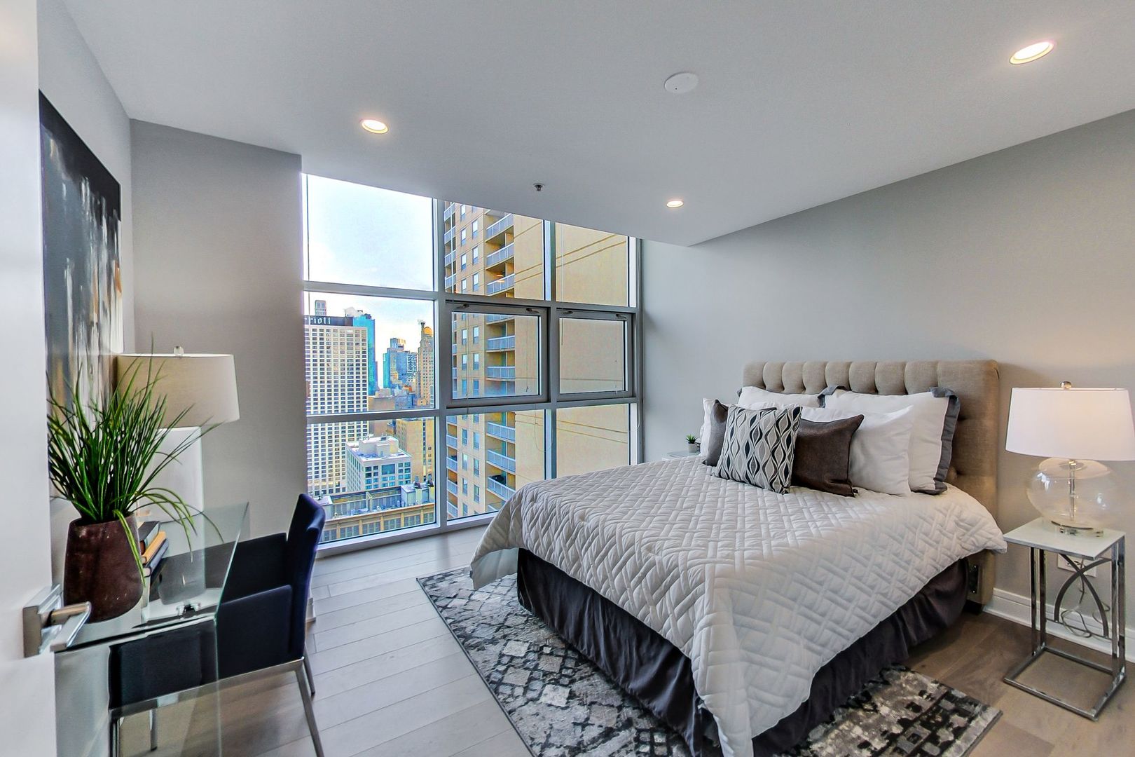 545 North Dearborn Street, Unit 3603 Chicago, IL 60654 - Photo 28 of 42 a bedroom with a large bed and a potted plant