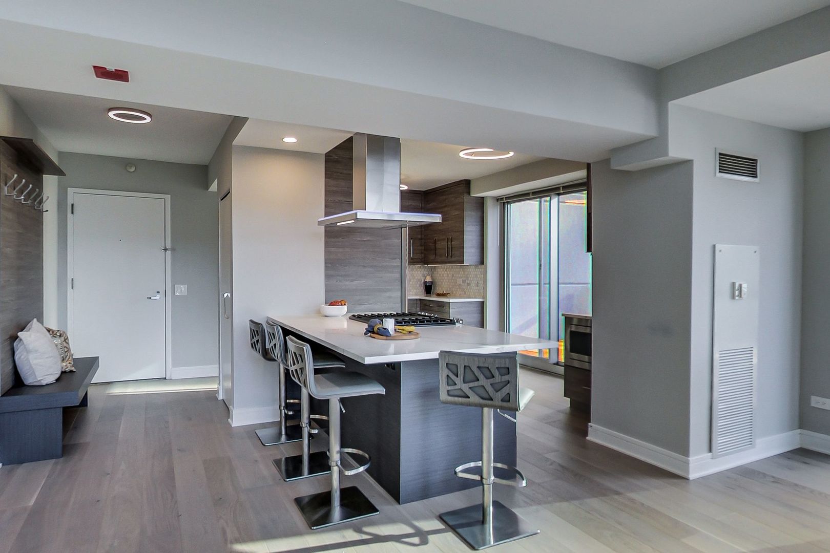 545 North Dearborn Street, Unit 3603 Chicago, IL 60654 - Photo 6 of 42 a kitchen with stainless steel appliances a table and chairs in it