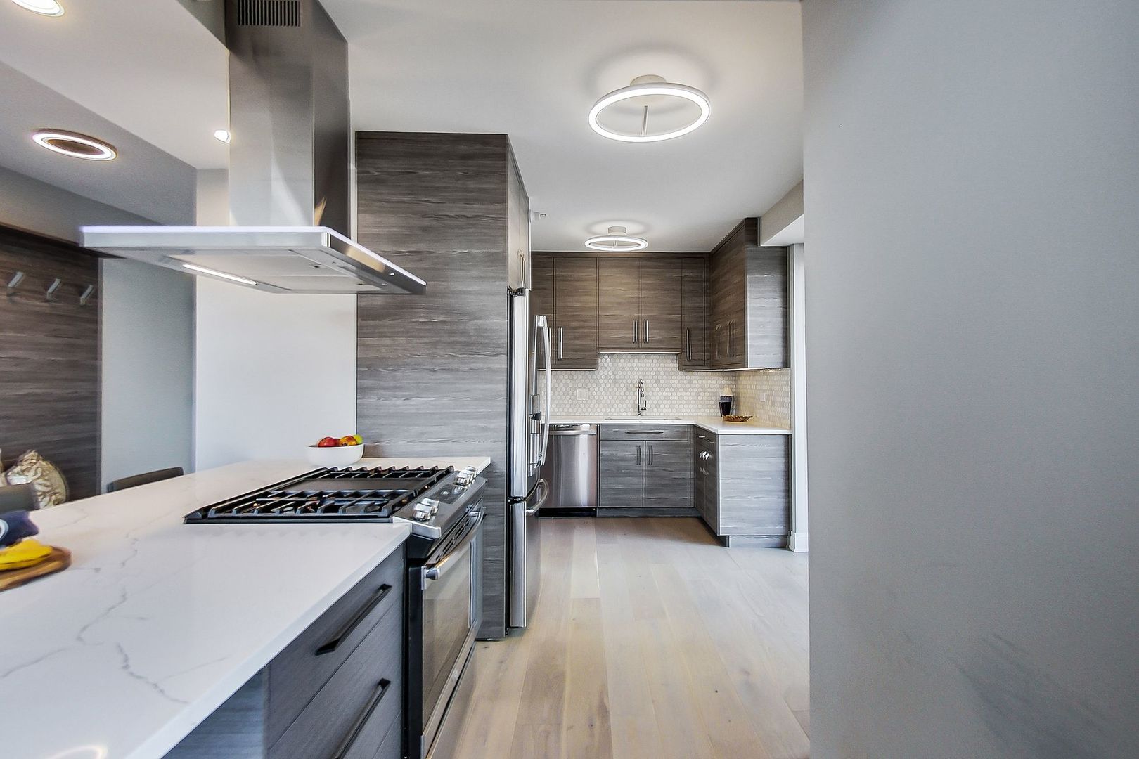 545 North Dearborn Street, Unit 3603 Chicago, IL 60654 - Photo 7 of 42 a kitchen that has a sink a stove and a wooden floor