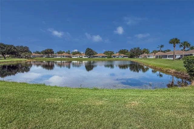 a view of a lake with houses in the back