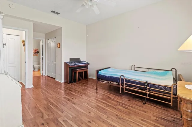 a view of a room with wooden floor and furniture